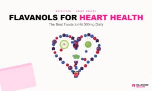 Flat-lay arrangement of flavanol-rich foods including plums, blackberries, cranberries, blueberries, green tea, and apples forming a heart shape on white background