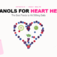 Flat-lay arrangement of flavanol-rich foods including plums, blackberries, cranberries, blueberries, green tea, and apples forming a heart shape on white background