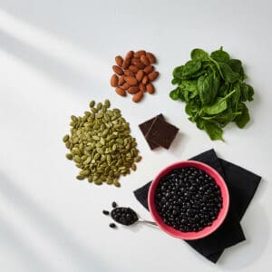 Magnesium-rich whole foods including pumpkin seeds, almonds, and spinach
